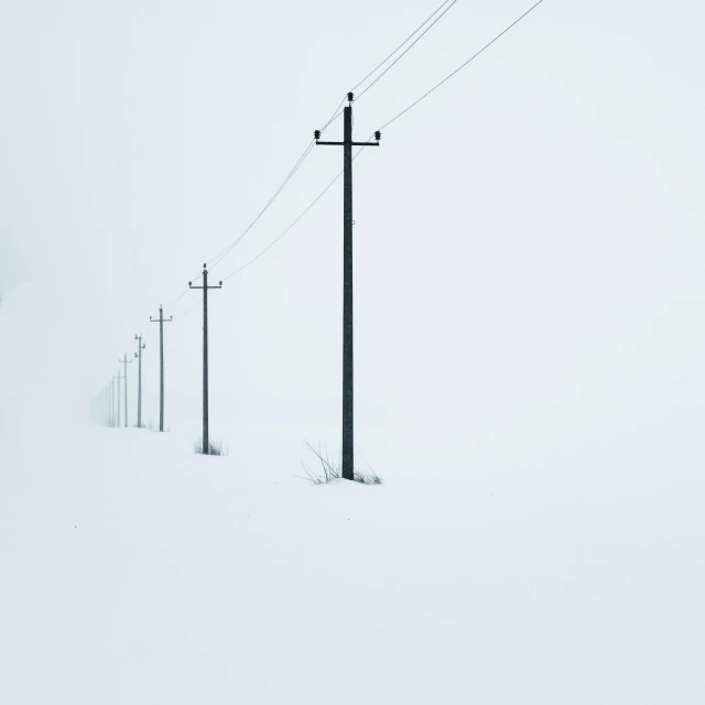 a man riding skis down a snow covered slope, an album cover, by Leo Leuppi, pexels contest winner, postminimalism, telephone wires, snowstorm ::5, electrical cables, lined up horizontally