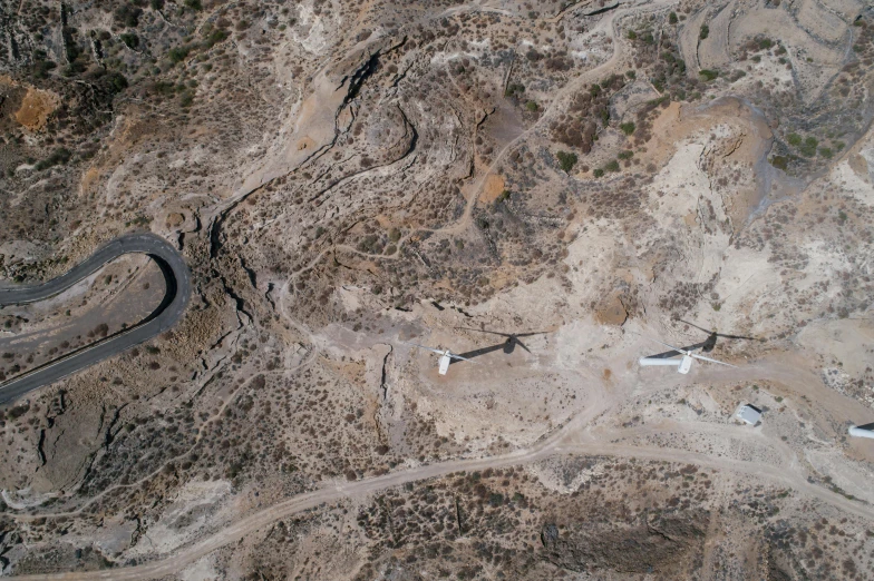 a couple of airplanes that are flying in the sky, by Lee Loughridge, pexels contest winner, les nabis, aerial view of an ancient land, rocky ground with a dirt path, alvaro siza, cyprus