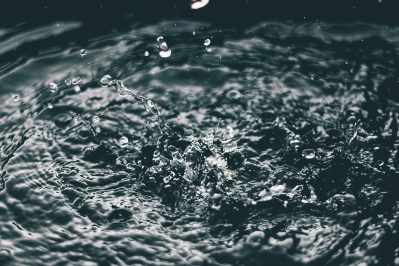 a black and white photo of a splash of water, unsplash, hurufiyya, flooding, dark blue water, instagram post, heavy rain