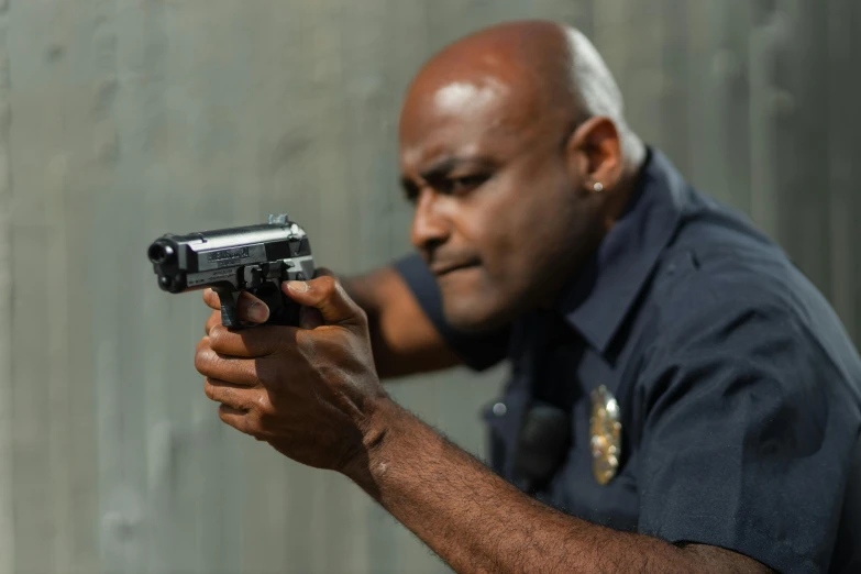 a man in a police uniform holding a gun, pexels contest winner, filmstill, shot from the side, next gen, getty images proshot