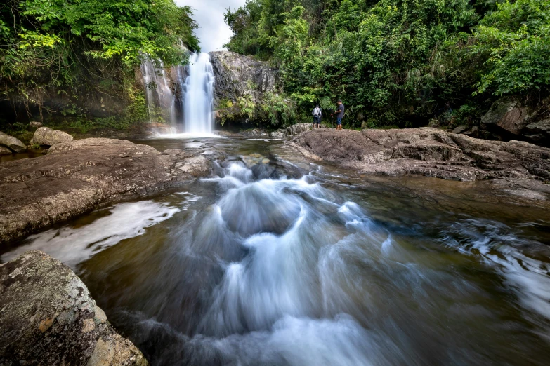 a waterfall flowing through a lush green forest, hurufiyya, fan favorite, tamborine, ancient ruins and waterfalls, thumbnail