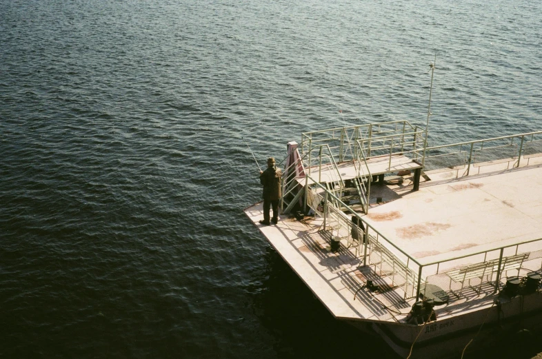 a couple of people standing on top of a boat, by Attila Meszlenyi, hurufiyya, boat dock, 33mm photo