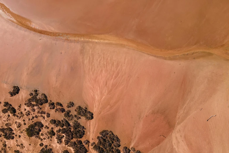 a bird's eye view of a desert landscape, by Lee Loughridge, pexels contest winner, land art, flowing salmon-colored silk, no trees ， hyper detailed, outback, 3/4 view from below