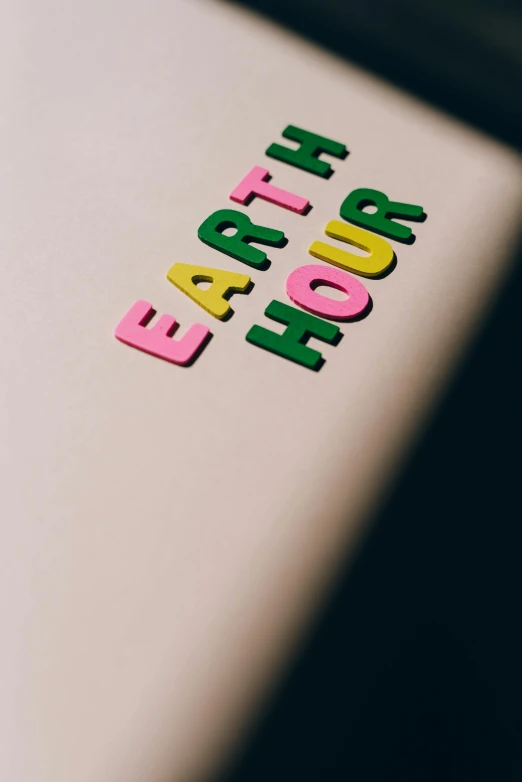 a laptop computer sitting on top of a table, by Carey Morris, trending on unsplash, graffiti, earthship, its hour come round at last, high angle close up shot, earth and pastel colors