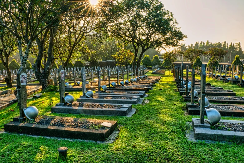 a cemetery filled with lots of tombstones and trees, by Daniel Lieske, shutterstock, sri lankan landscape, evening sun, fan favorite, panoramic shot