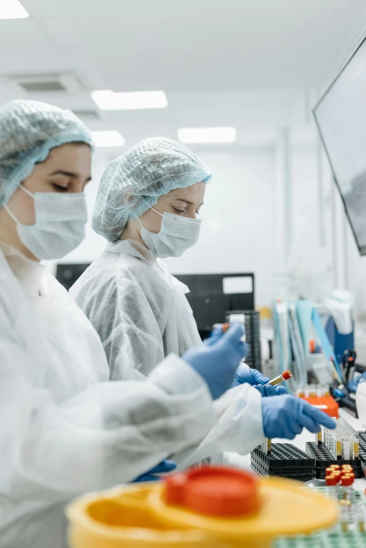 a group of people working in a factory, a picture, shutterstock, medical lab, high resolution photo, thumbnail, small in size