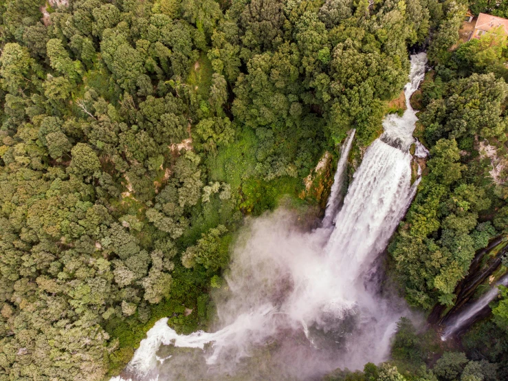 an aerial view of a waterfall in the middle of a forest, hurufiyya, tourism photography, multiple stories, thumbnail