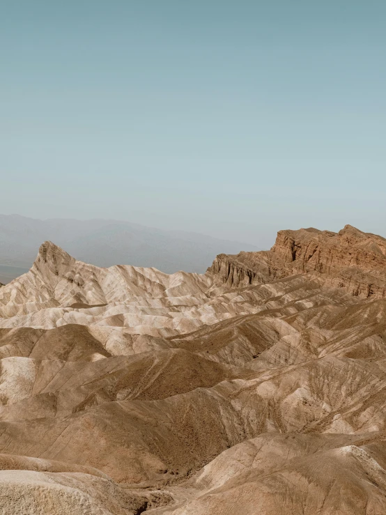 a group of people standing on top of a mountain, a matte painting, by Carey Morris, unsplash contest winner, tonalism, death valley, shiny layered geological strata, panoramic, instagram story