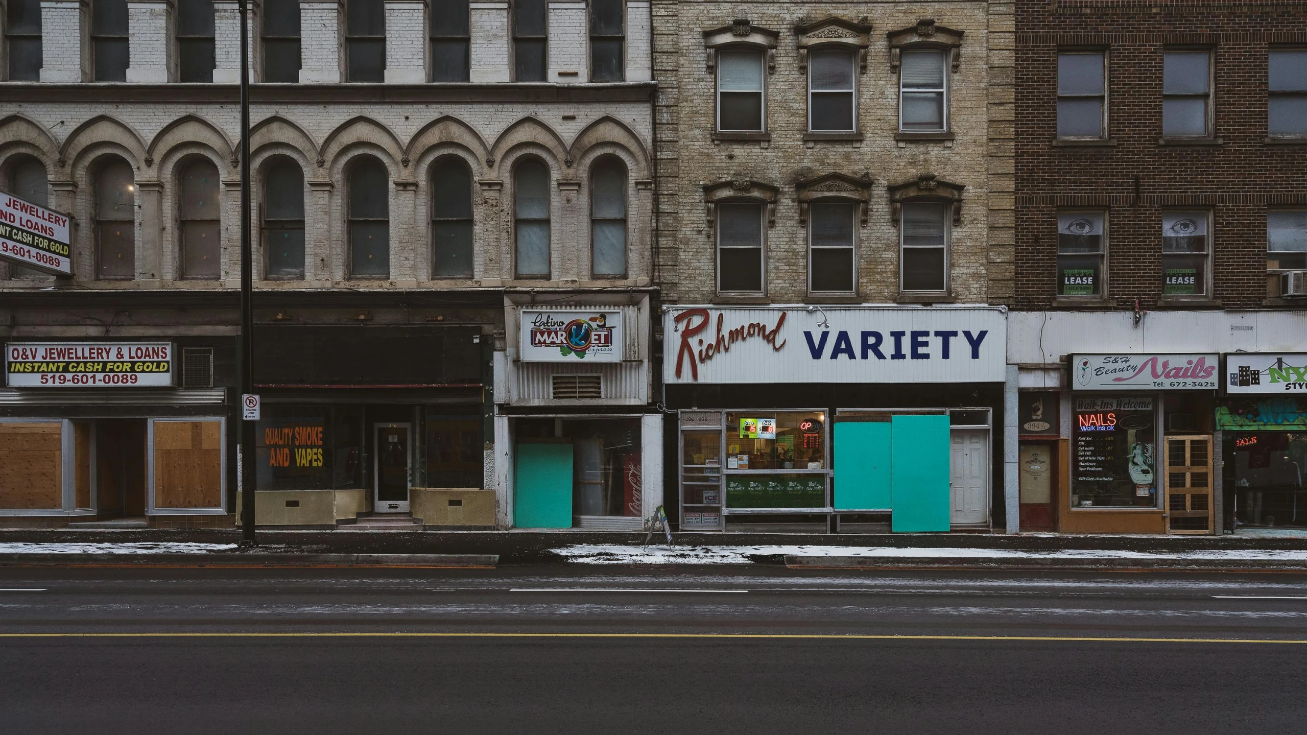 a row of buildings on a city street, a photo, inspired by Richard Estes, pexels contest winner, visual art, old signs, riverdale, alec soth : : love, paisley