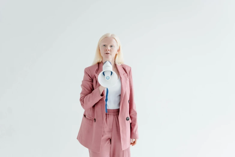 a woman in a pink suit and white shirt, inspired by Louisa Matthíasdóttir, unsplash, albino, with a stethoscope, off - white collection, white sky