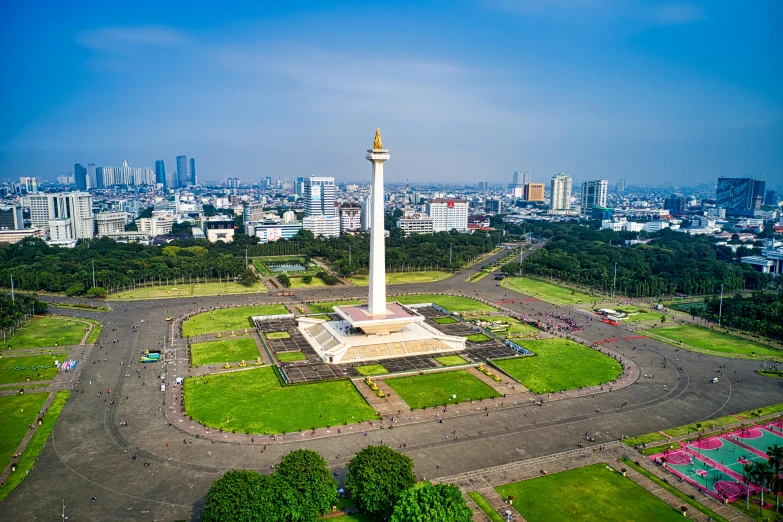 a large white monument sitting on top of a lush green field, by Bernardino Mei, pexels contest winner, hurufiyya, city square, batik, obelisk, central hub