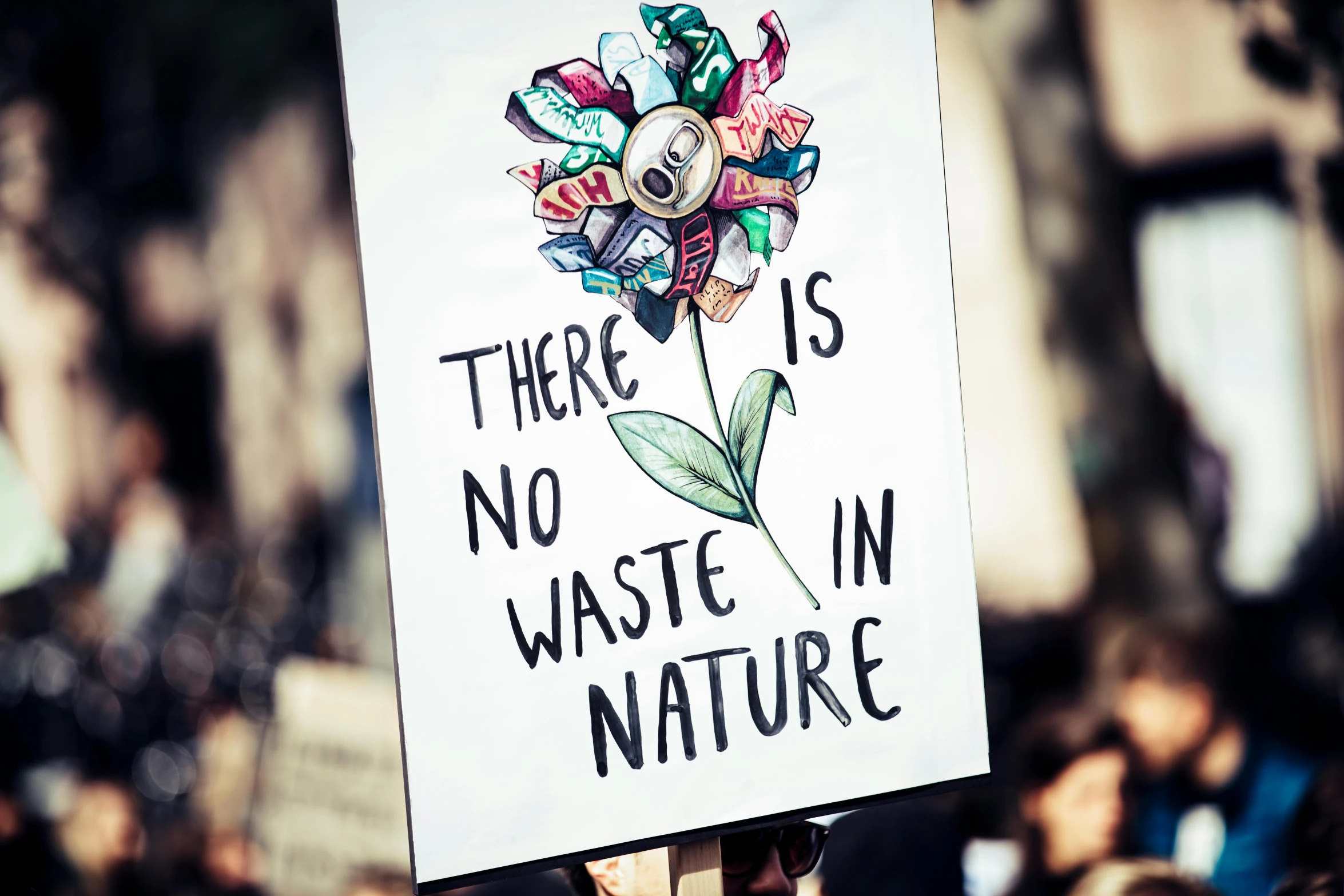 a person holding a sign that says there is no waste in nature, a poster, by Julia Pishtar, pixabay, naturalism, clothes made out of flower, protest, instagram post, 🚿🗝📝