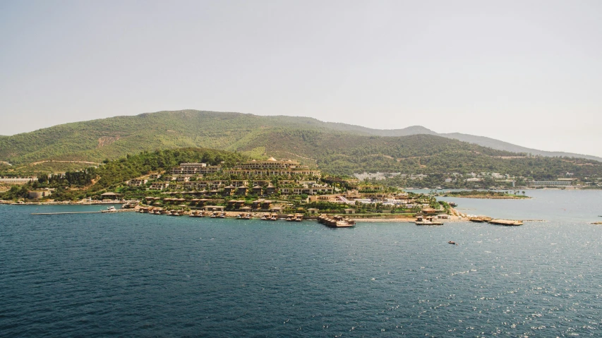 a large body of water with a mountain in the background, a tilt shift photo, hurufiyya, resort, arma 3, floating palace, a photo of the ocean