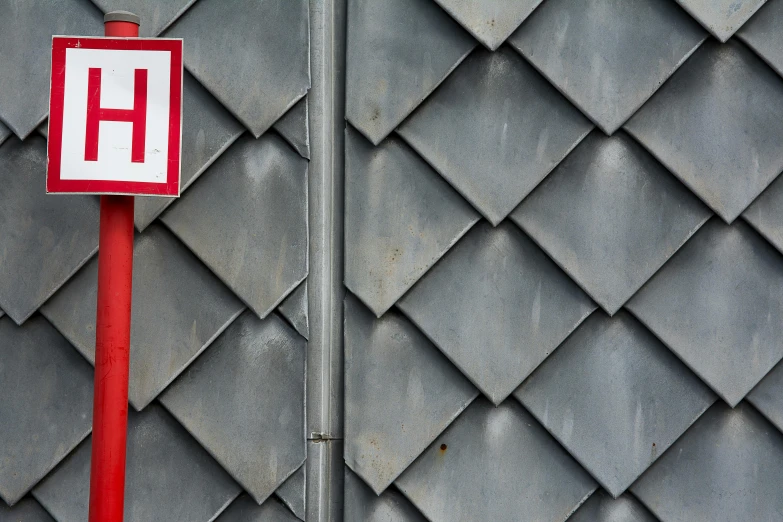 a red and white sign sitting on the side of a building, an album cover, unsplash, hypermodernism, metal scales, grey, emergency, cross-hatchings