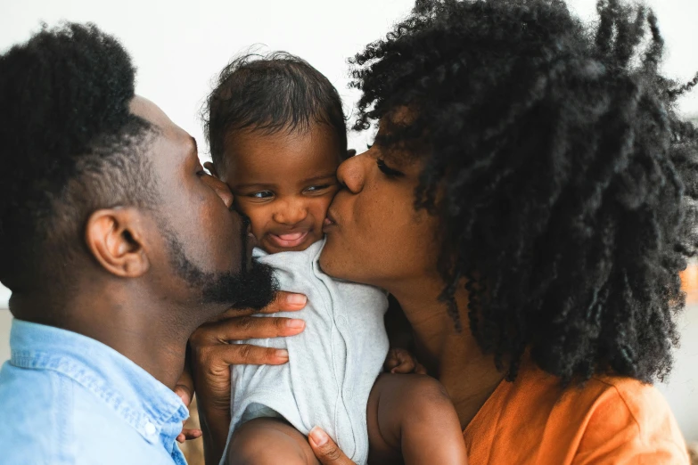 a close up of a person kissing a baby, black people, husband wife and son, chemistry, smaller mouth