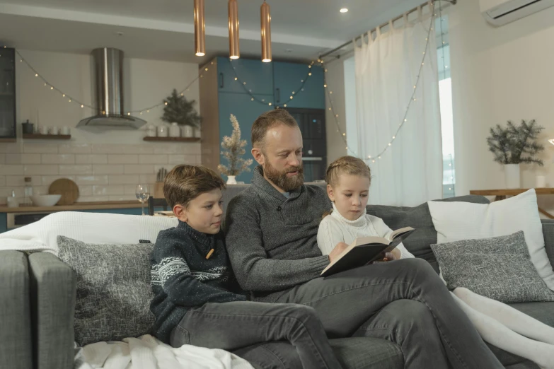 a man and two children sitting on a couch, pexels contest winner, reading nook, avatar image, home video, maintenance photo