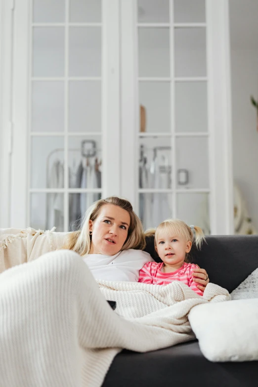 a woman and a little girl sitting on a couch, scandinavian, 4k press image, multiple stories, square