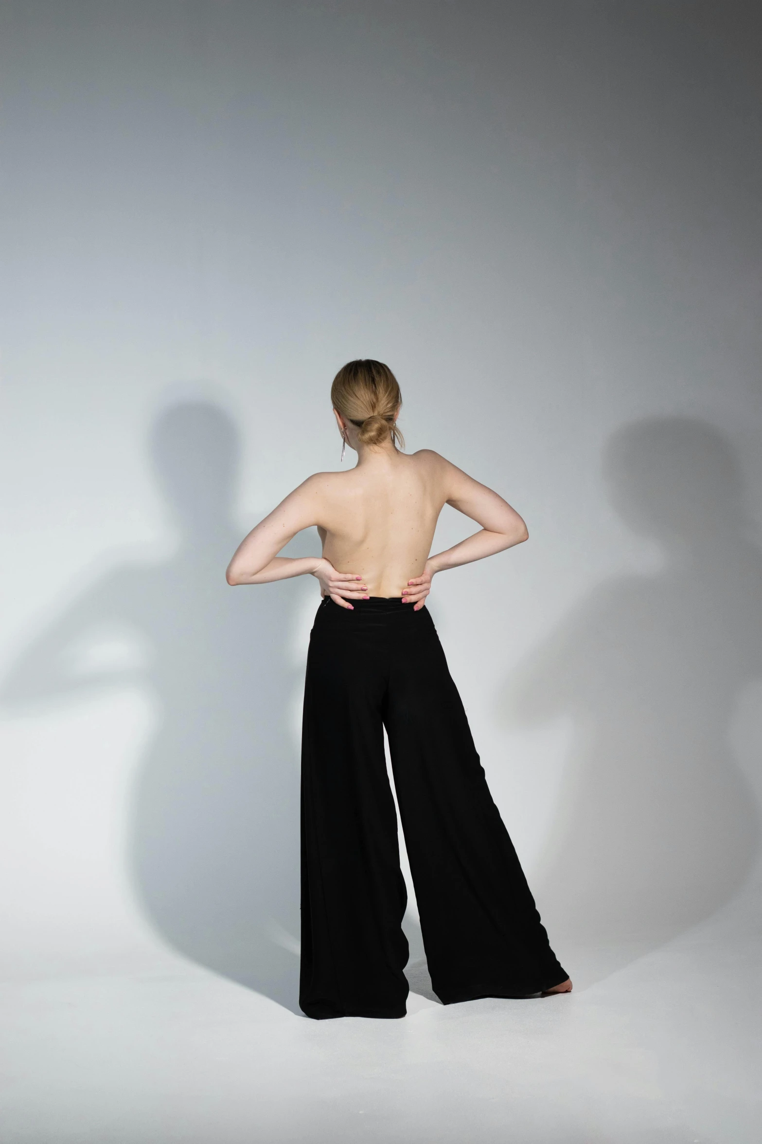 a woman standing with her back to the camera, inspired by Vanessa Beecroft, unsplash, arabesque, large pants, 3 - d shadows, 15081959 21121991 01012000 4k, doing an elegant pose over you