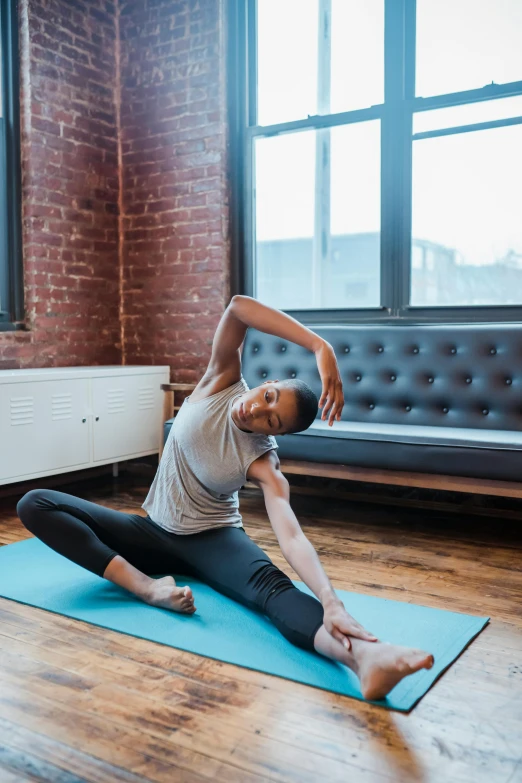 a woman doing a yoga pose in front of a window, doing splits and stretching, leslie zhang, square, high quality picture