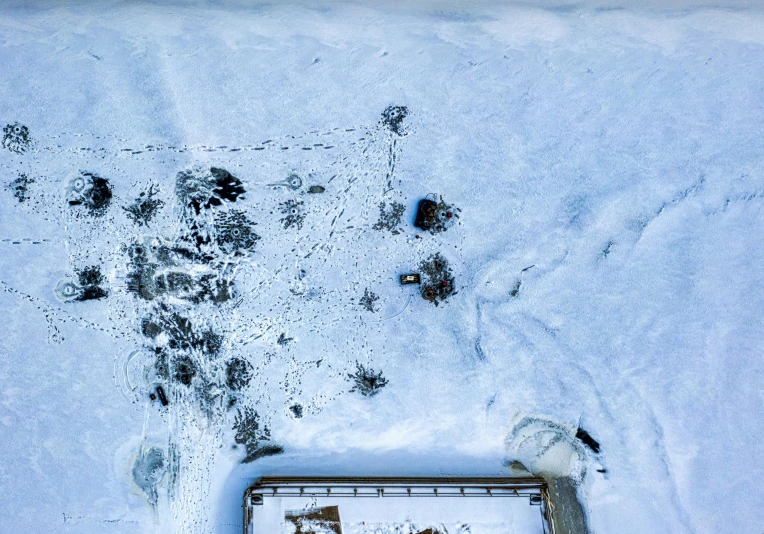 a picture of some animal tracks in the snow, an album cover, by Petr Brandl, pexels contest winner, land art, background aerial battle, background image, buildings covered in black tar, detailed photo 8 k