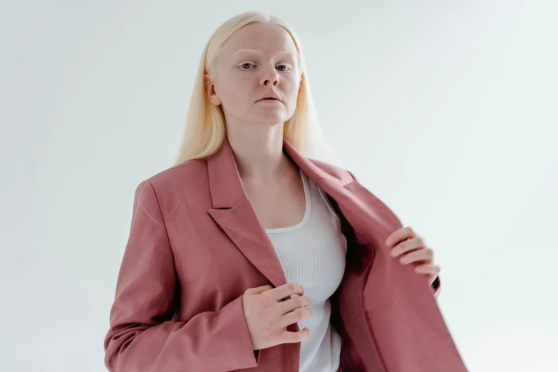a woman in a pink blazer poses for a picture, an album cover, inspired by Louisa Matthíasdóttir, trending on pexels, renaissance, intense albino, greta thunberg, pale grey skin, alessio albi