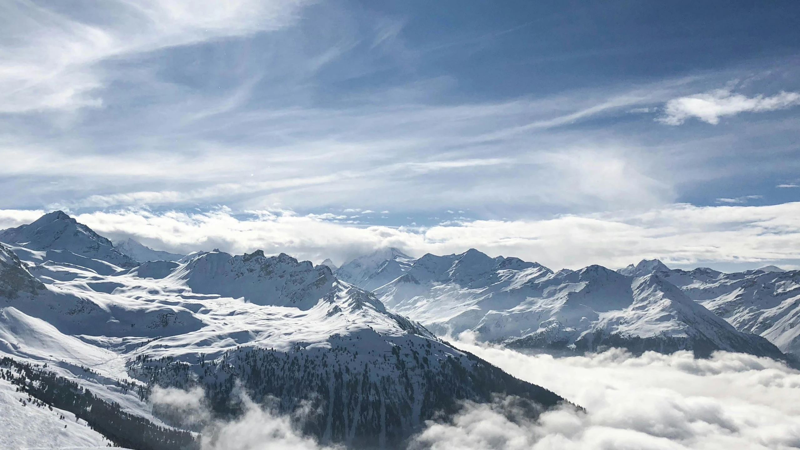 a man riding skis down a snow covered slope, by Daniel Seghers, pexels contest winner, romanticism, panorama view of the sky, view above the clouds, whistler, “ aerial view of a mountain