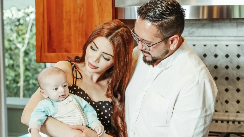 a man and woman holding a baby in a kitchen, young beautiful amouranth, profile image, fan favorite, zigor samaniego style