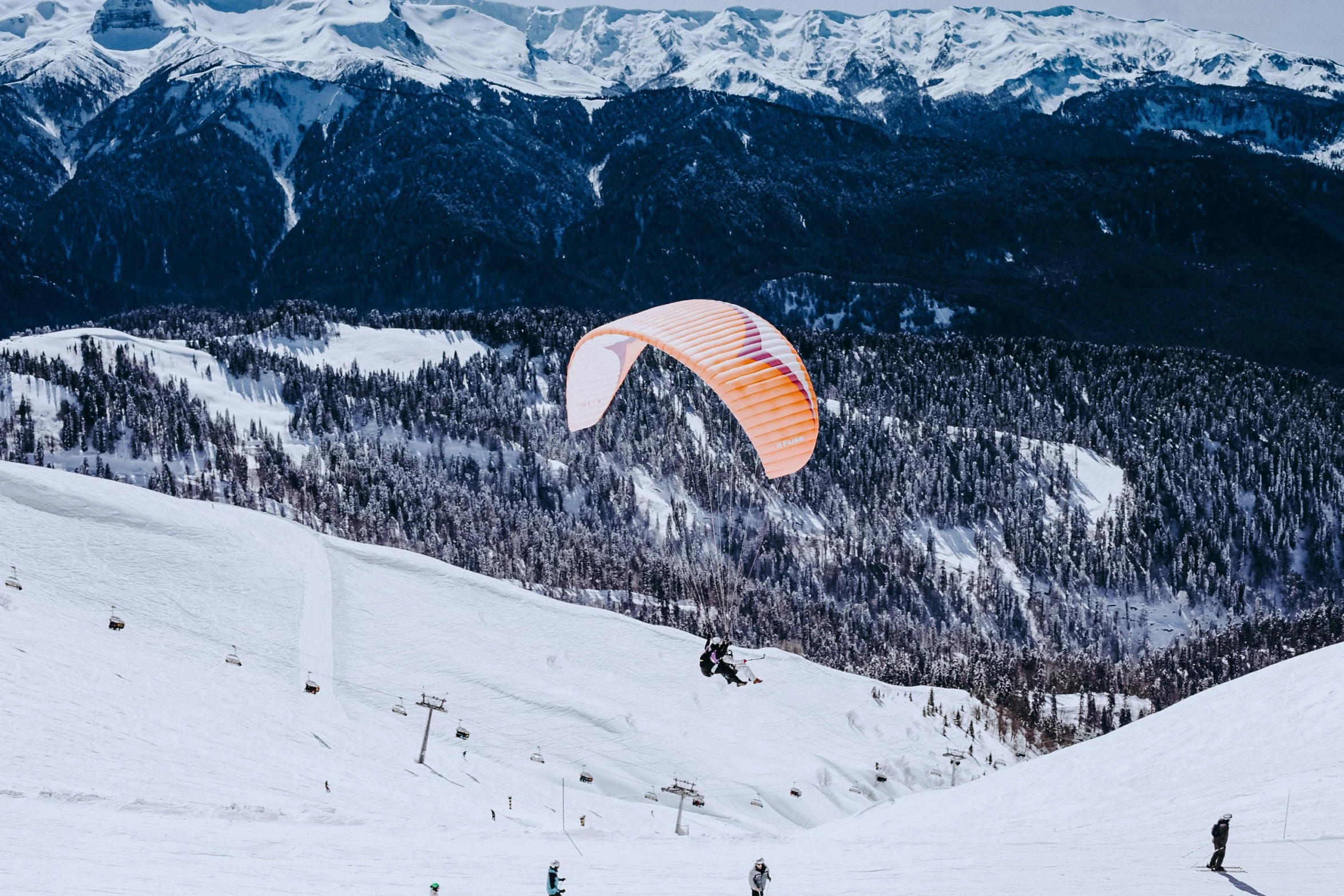 a person parasailing in the snow with mountains in the background, by Julia Pishtar, pexels contest winner, panorama view, geiger, exterior shot, thumbnail