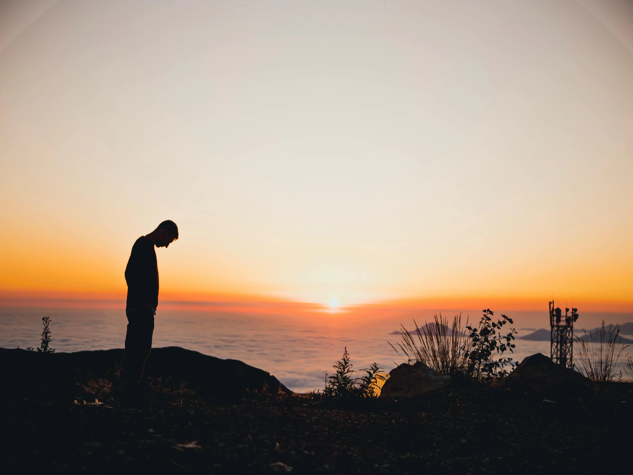 a man standing on top of a hill next to the ocean, pexels contest winner, romanticism, praying at the sun, devastated, profile image, predawn