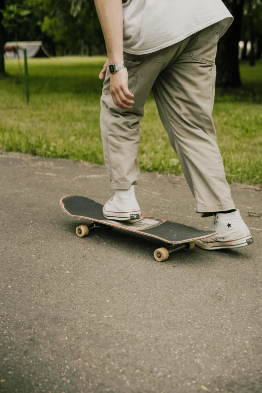 a man riding a skateboard down a sidewalk, trending on pexels, hyperrealism, brown pants, plain background, at a park, a pair of ribbed