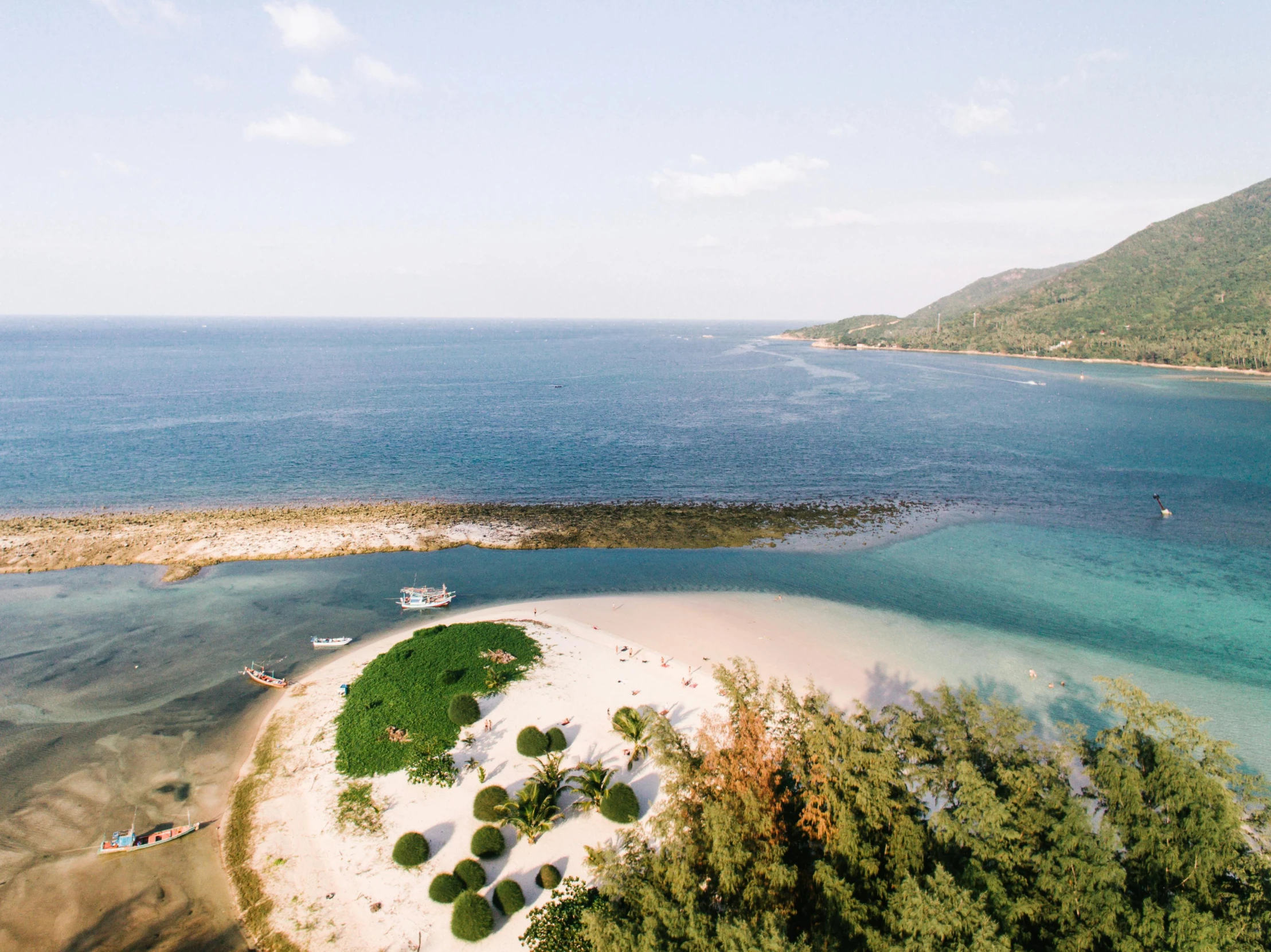 a small island in the middle of the ocean, pexels contest winner, beach setting, guangjian, sea - green and white clothes, conde nast traveler photo