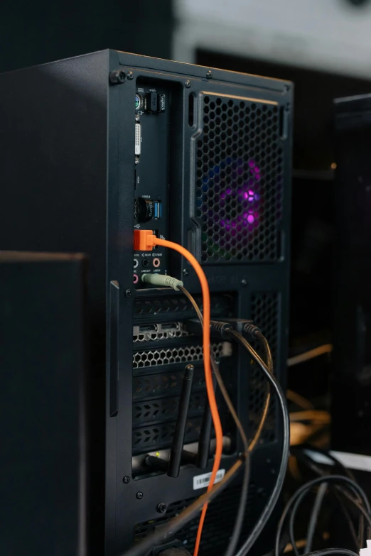 a desktop computer sitting on top of a desk, by Jason Felix, orange and purple electricity, server in the middle, medium close - up ( mcu ), black wired cables