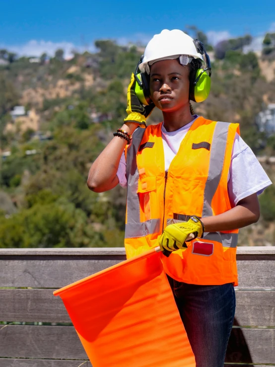 a construction worker talking on a cell phone, a portrait, shutterstock contest winner, portrait willow smith, orange safety vest, in the hillside, hollywood standard