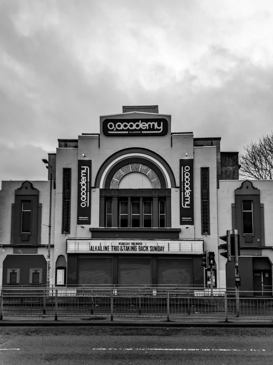 a black and white photo of a movie theater, by Steve Prescott, pexels contest winner, art nouveau, hull is a opera house, 2 0 5 6 x 2 0 5 6, gloomy skies, academy headmaster