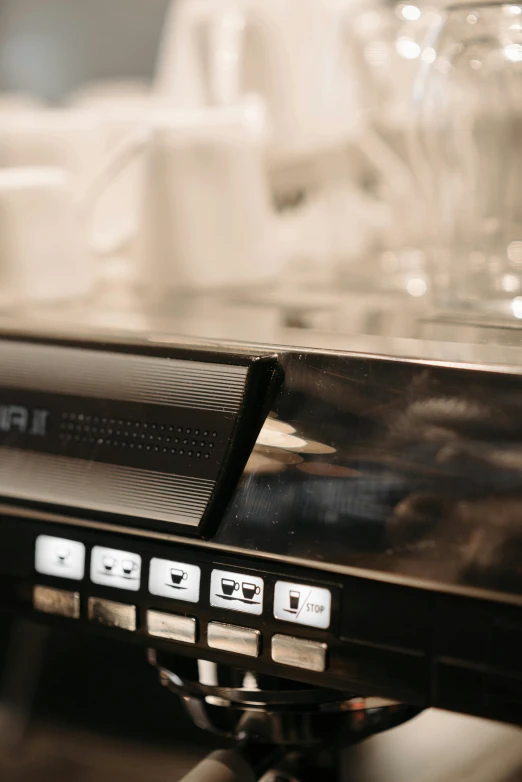 a coffee machine sitting on top of a counter, by Puru, glowing details, close up shot from the side, servers, detailed product image