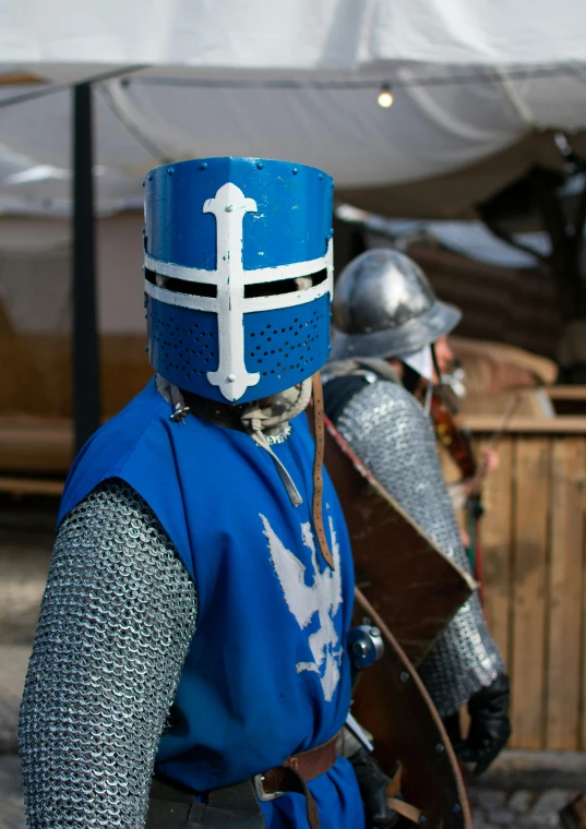 a couple of men in armor standing next to each other, blue, knight helmet, tournament, medieval photograph