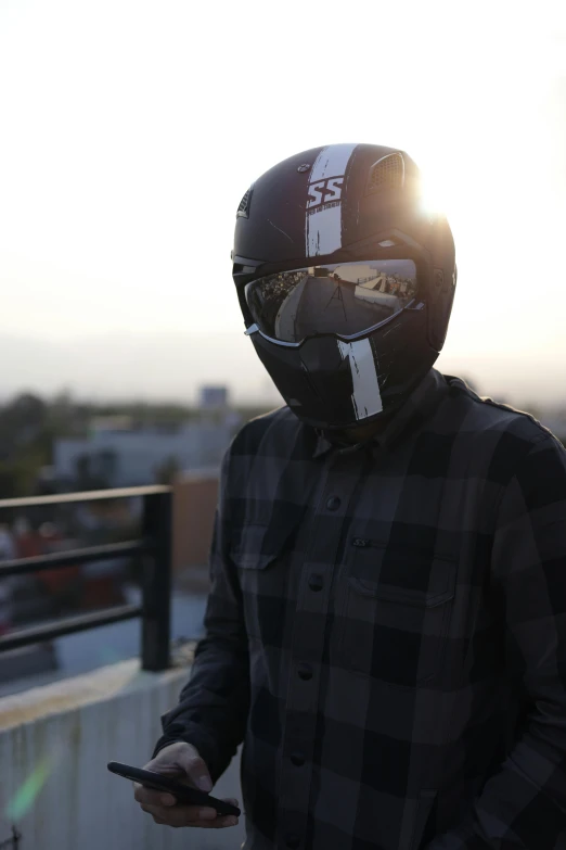 a person wearing a helmet and holding a cell phone, profile image, morning time, discord profile picture, skimask