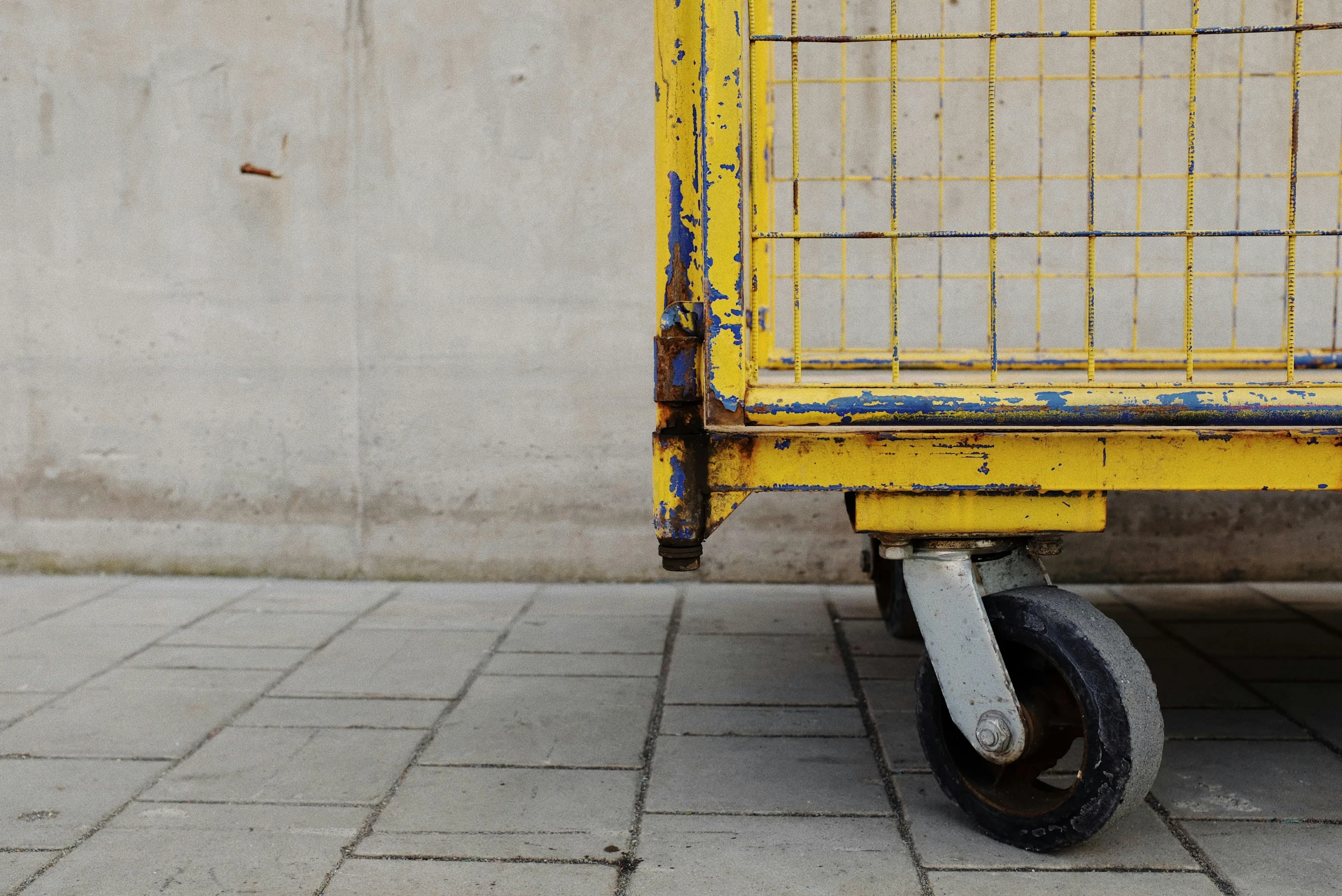 a yellow cart sitting on top of a sidewalk, by Andries Stock, unsplash, grungy steel, square, pallet, ultra - realistic