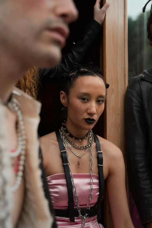 a group of people standing next to each other, inspired by Nan Goldin, unsplash, international gothic, pearls and chains, punk woman, pout, ashteroth