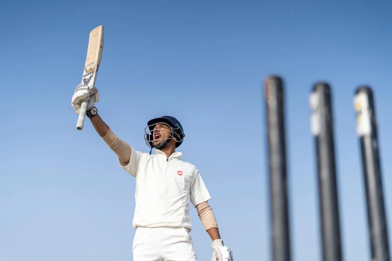 a man holding a bat on top of a field, a portrait, pexels contest winner, white uniform, showing victory, kyza saleem, profile image