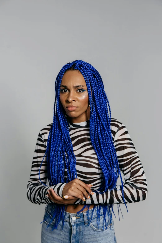 a woman with blue dreadlocks posing for a picture, an album cover, inspired by Jessie Alexandra Dick, trending on pexels, black arts movement, white braids, solid background, high resolution photo, l critical role