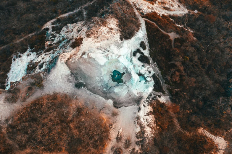 an aerial view of a body of water, inspired by Filip Hodas, unsplash contest winner, an ice volcano, white and teal metallic accents, underground mine, thumbnail
