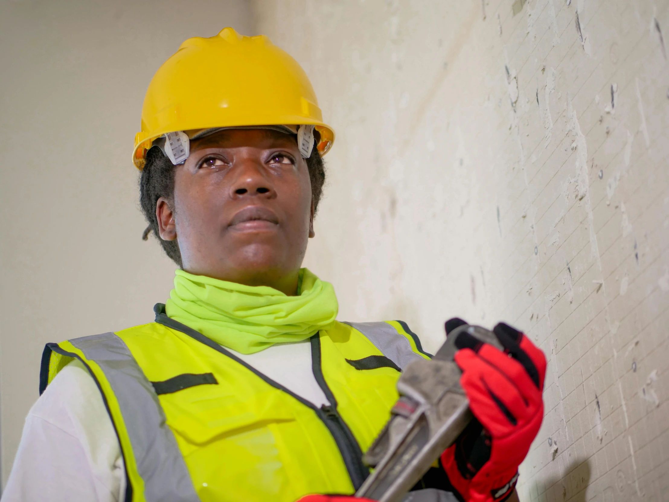 a woman in a hard hat and safety vest holding a wrench, a portrait, inspired by Afewerk Tekle, pexels contest winner, androgynous male, as she looks up at the ceiling, african sybil, reconstruction