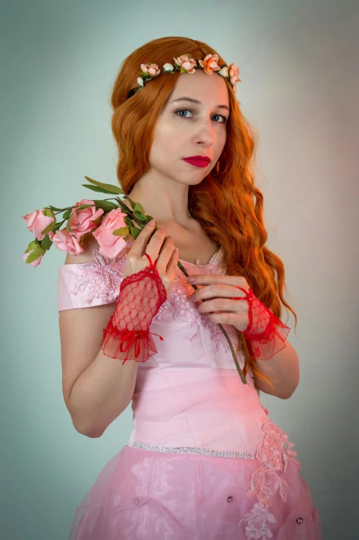 a woman in a pink dress with flowers in her hair, inspired by Pierre Auguste Cot, renaissance, triss merigold cosplay, cosplay photo, dressed in a frilly ((lace)), red gloves
