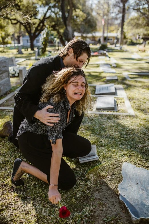 a woman kneeling next to a man in a cemetery, pexels contest winner, renaissance, crying and reaching with her arm, 15081959 21121991 01012000 4k, head bent back in laughter, carson ellis