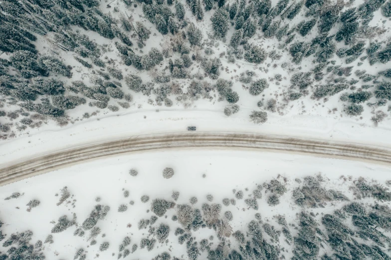 a car driving down a snow covered road, by Matthias Weischer, pexels contest winner, satellite imagery, fan favorite, circle, hunting
