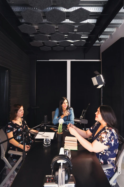 a group of people sitting around a conference table, studio recording, latinas, square, wine