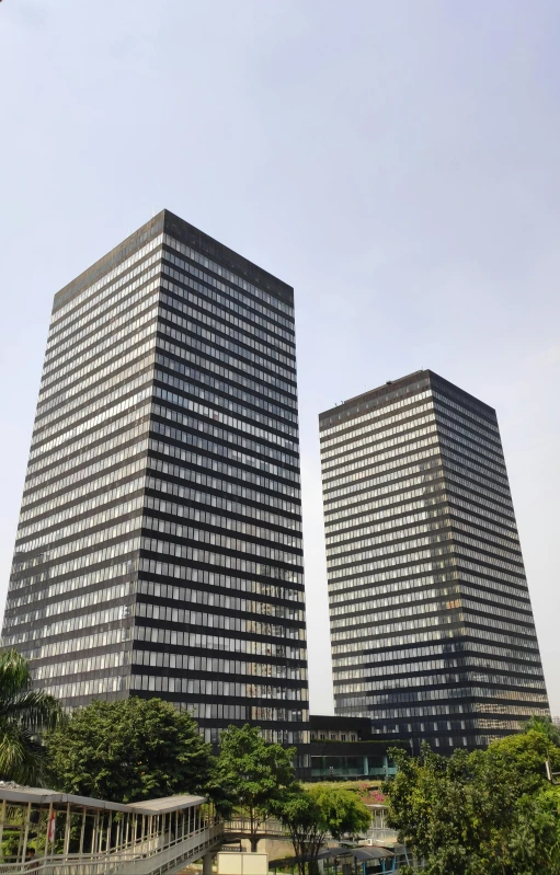 a couple of tall buildings sitting next to each other, brutalism, ((monolith)), european japanese buildings, wikipedia, square