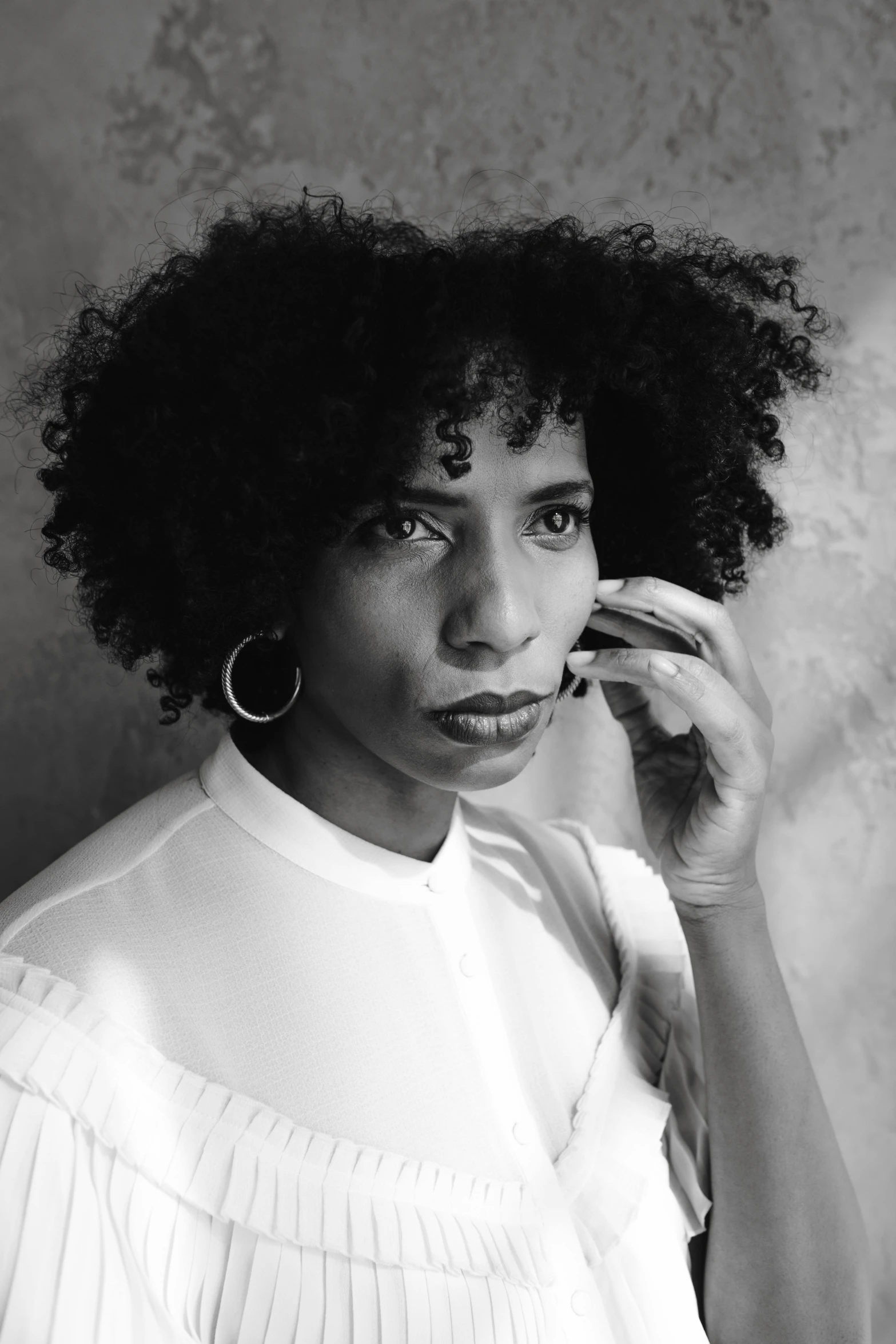 a black and white photo of a woman talking on a cell phone, black arts movement, curly bangs, square, studio portrait, aida muluneh