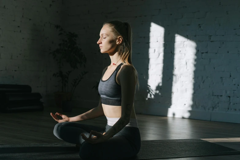 a woman sitting in a yoga position with her eyes closed, pexels contest winner, light and space, low quality photo, animation, mid morning lighting, media photo